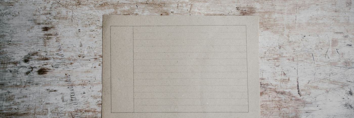 white paper on brown surface
