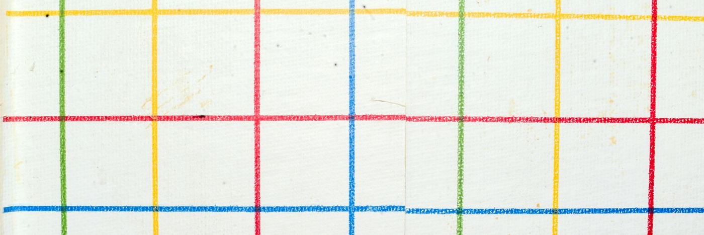 A grid of intersecting red, blue, yellow, and green lines on white paper